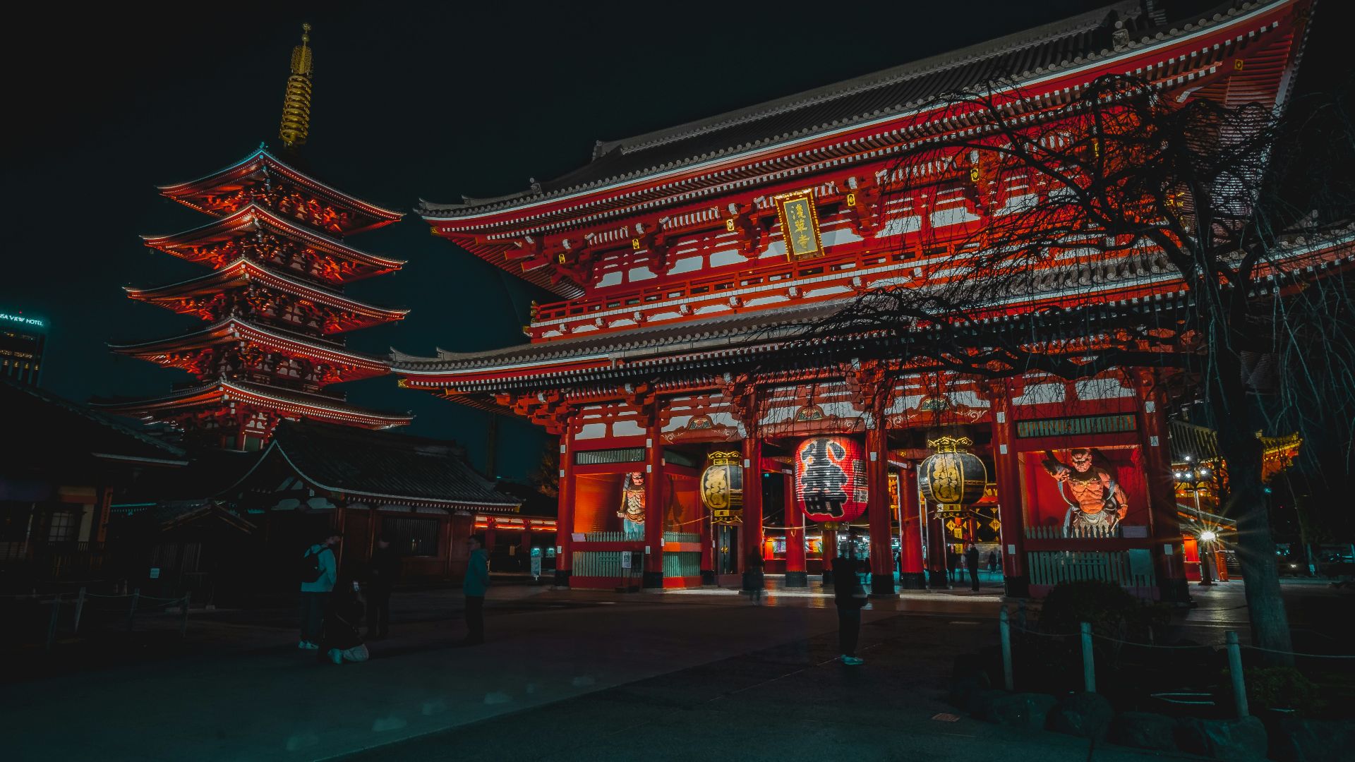 a tall building with red lights in front of it