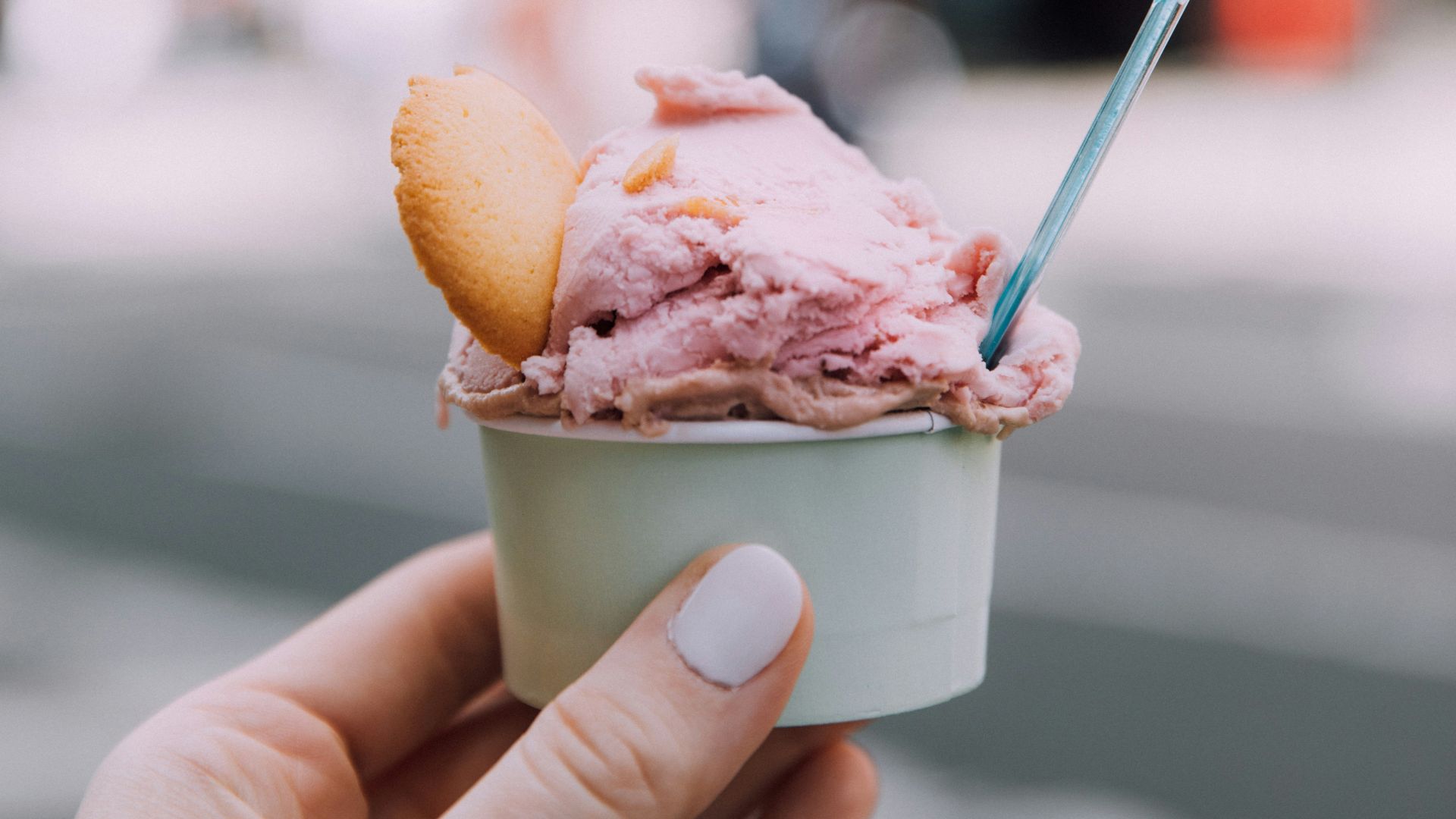 person holding ice cream cone with ice cream
