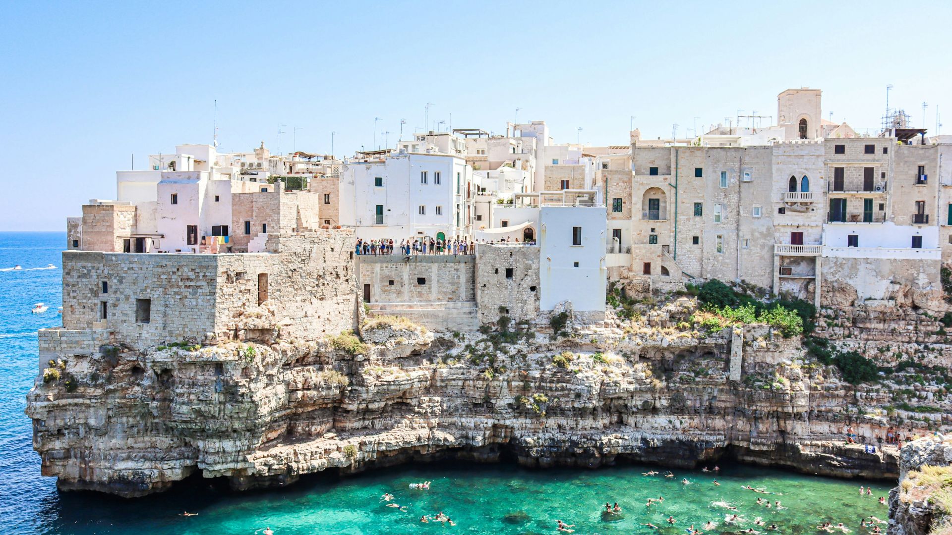 white concrete building beside body of water during daytime
