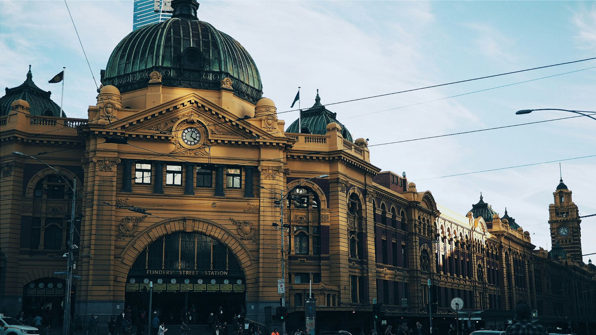 brown building with cars passing infront