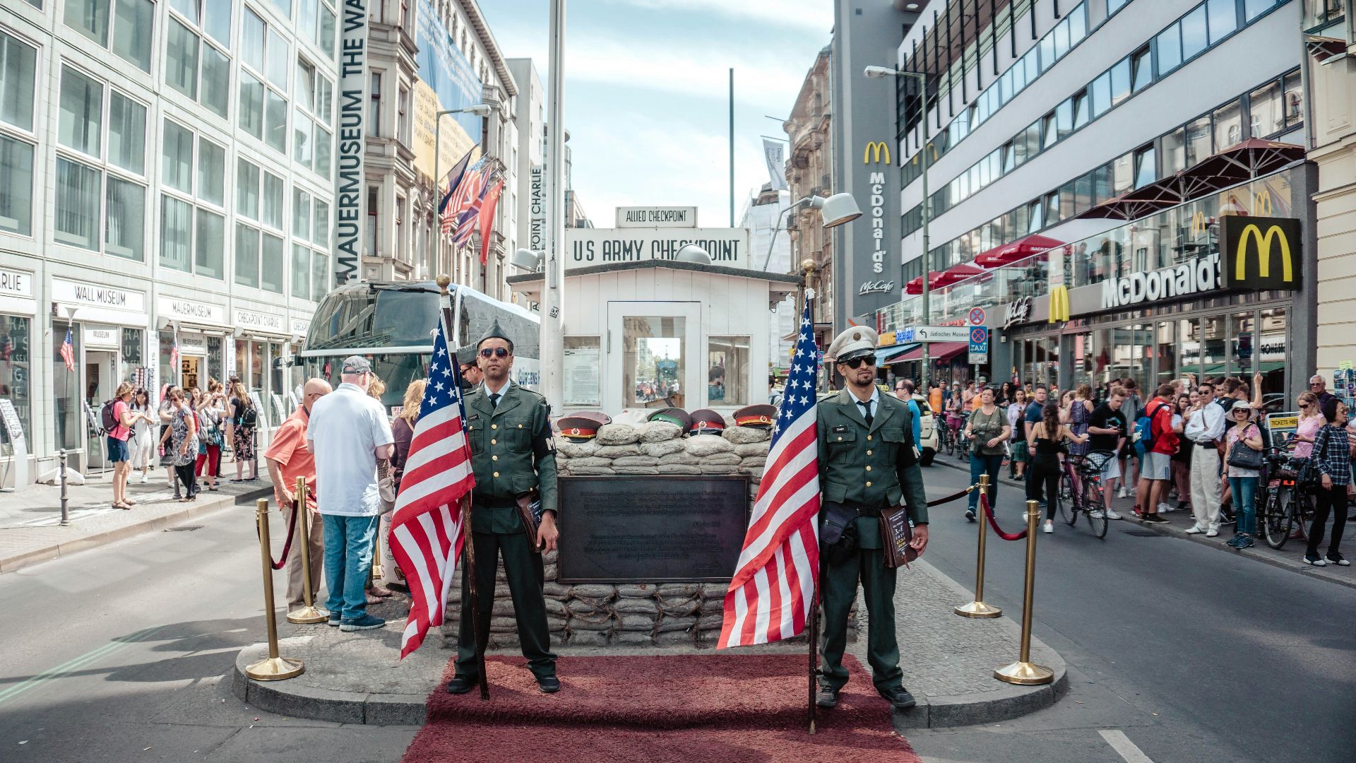 two men holding USA flags outdoors