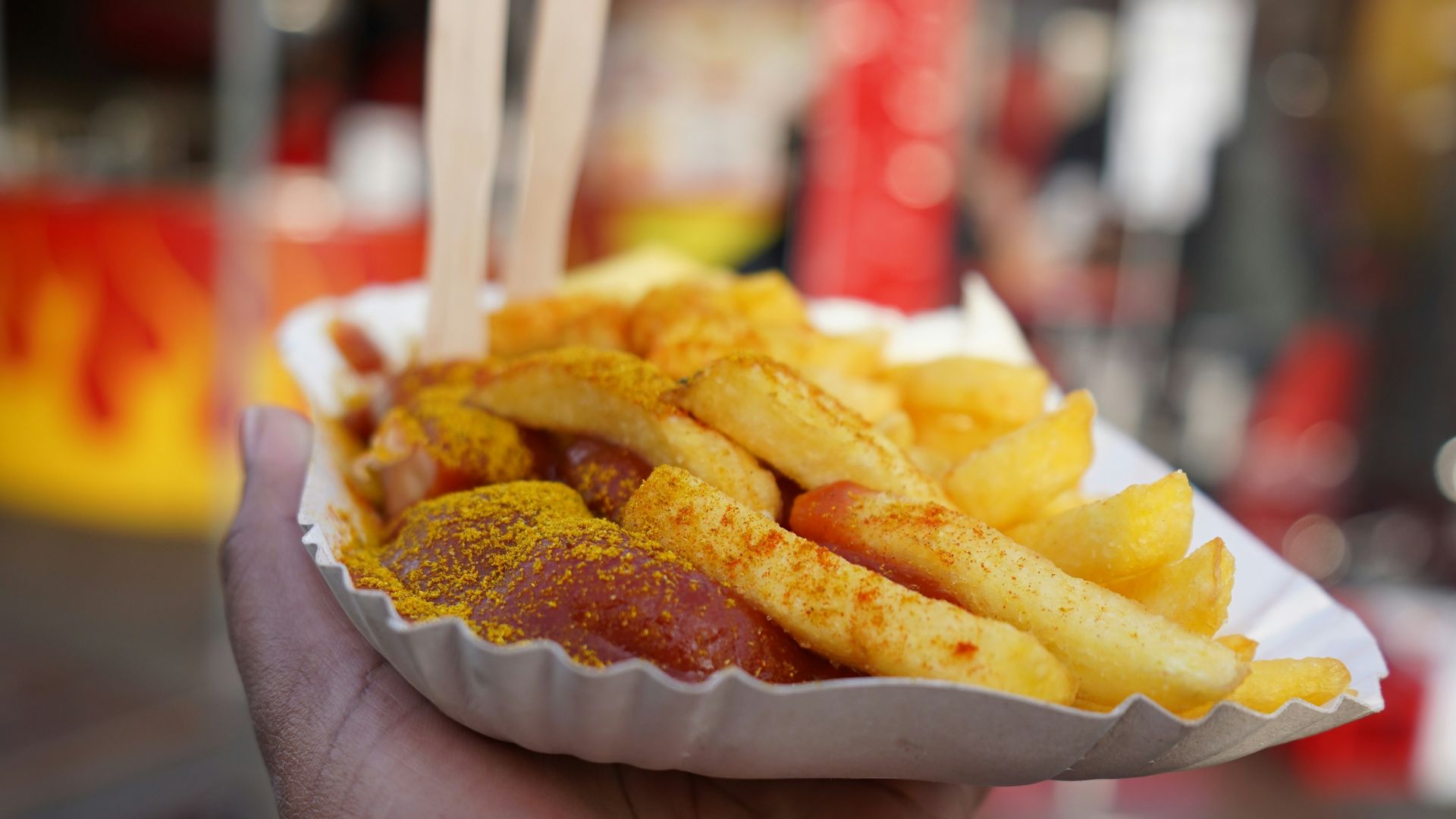 person holding burger with cheese