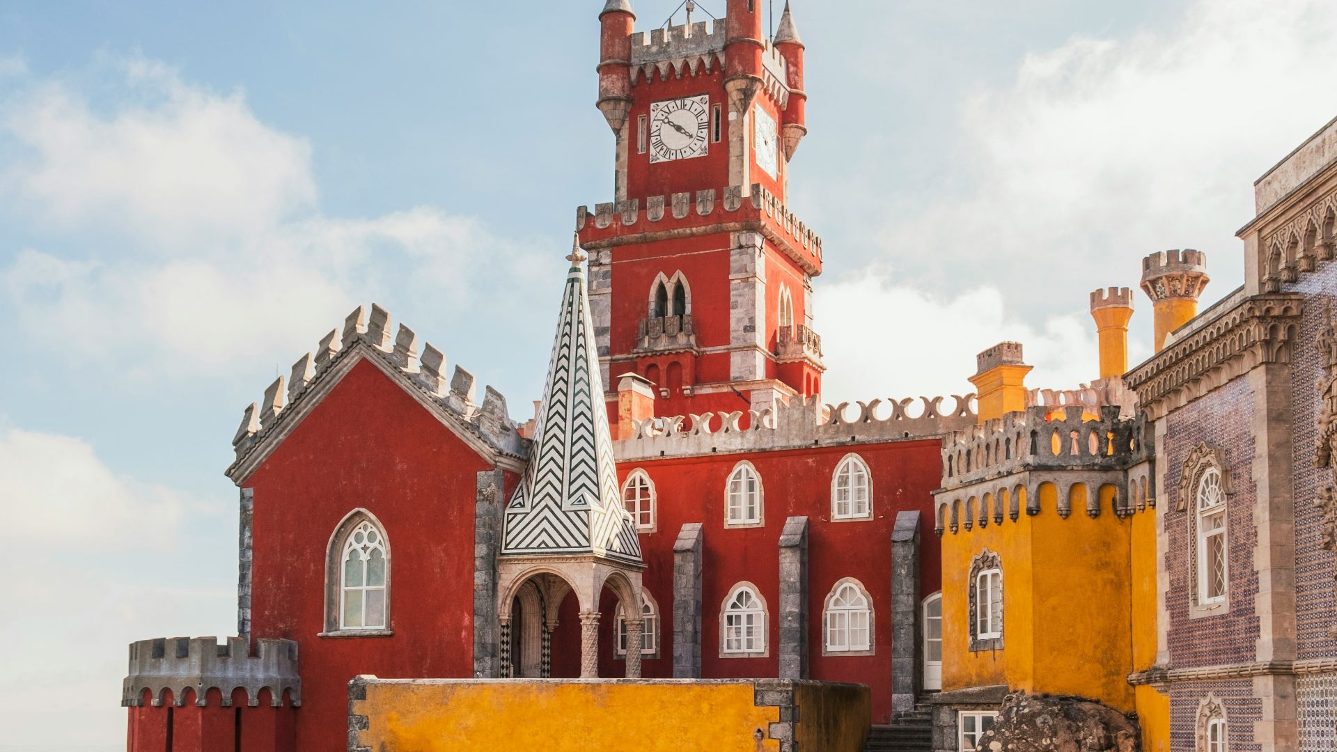 yellow and red concrete building under clear blue sky