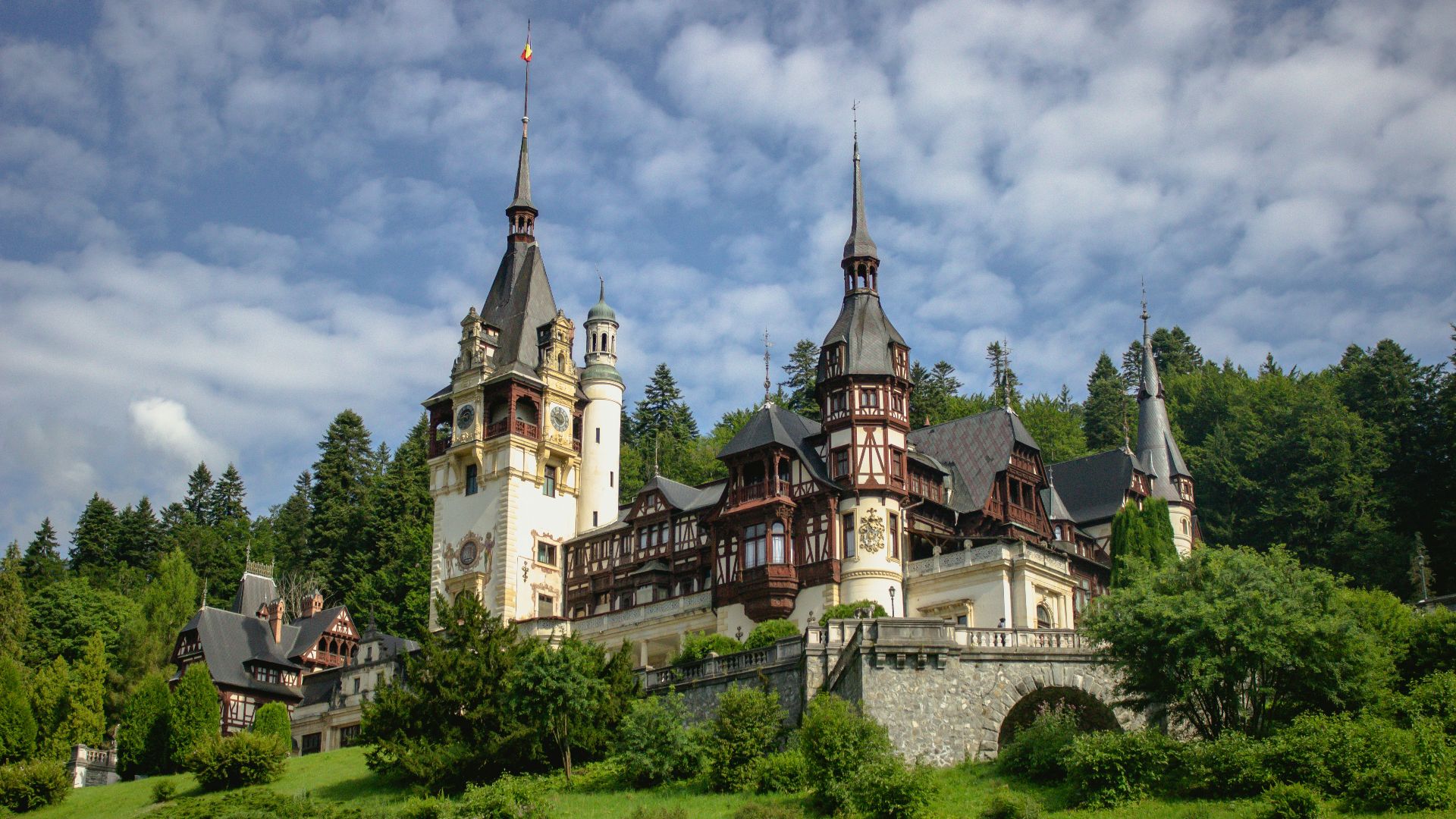 a large castle with towers on top of a hill
