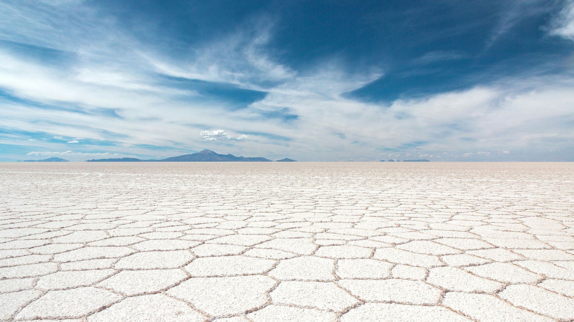 dry soil under white clouds and blue sky at daytime