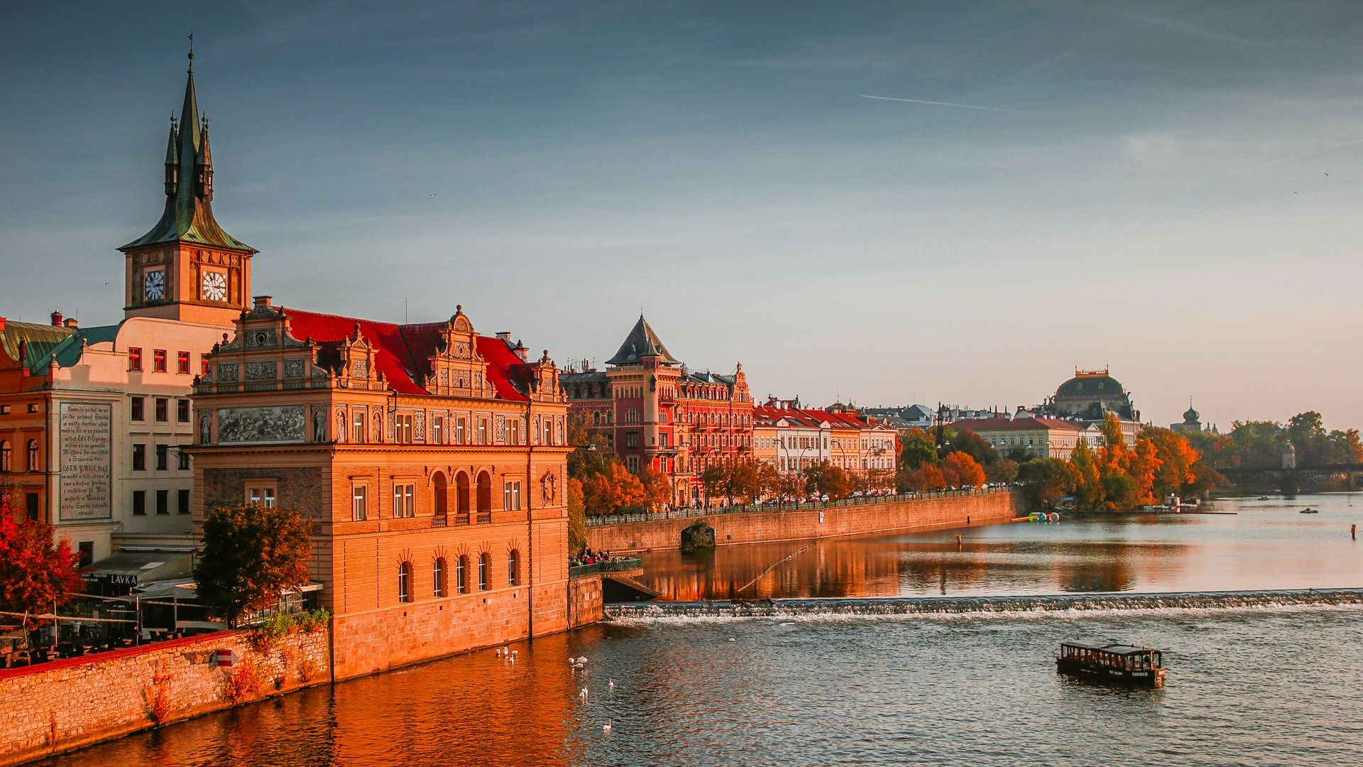 photo of boat on body of water near high-rise buildings
