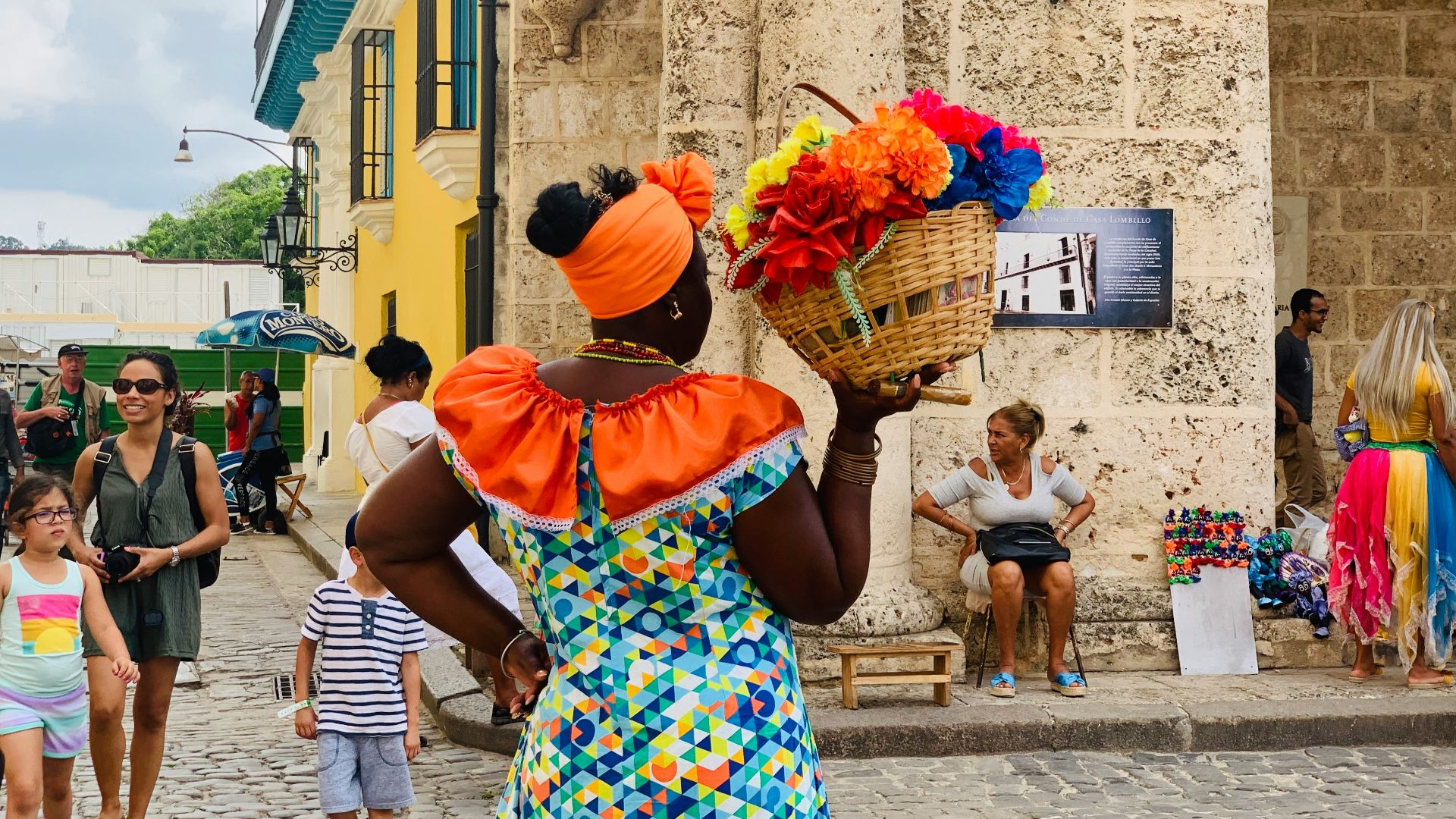 standing woman holding basket of flowers