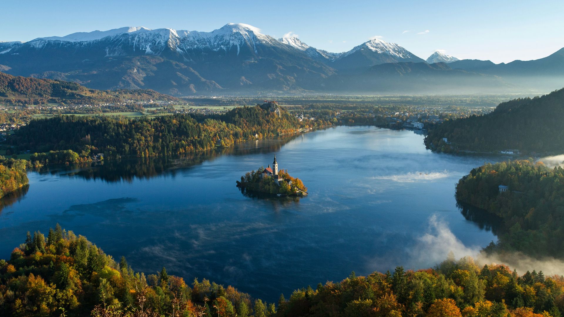 island surrounded by water and mountains at daytime