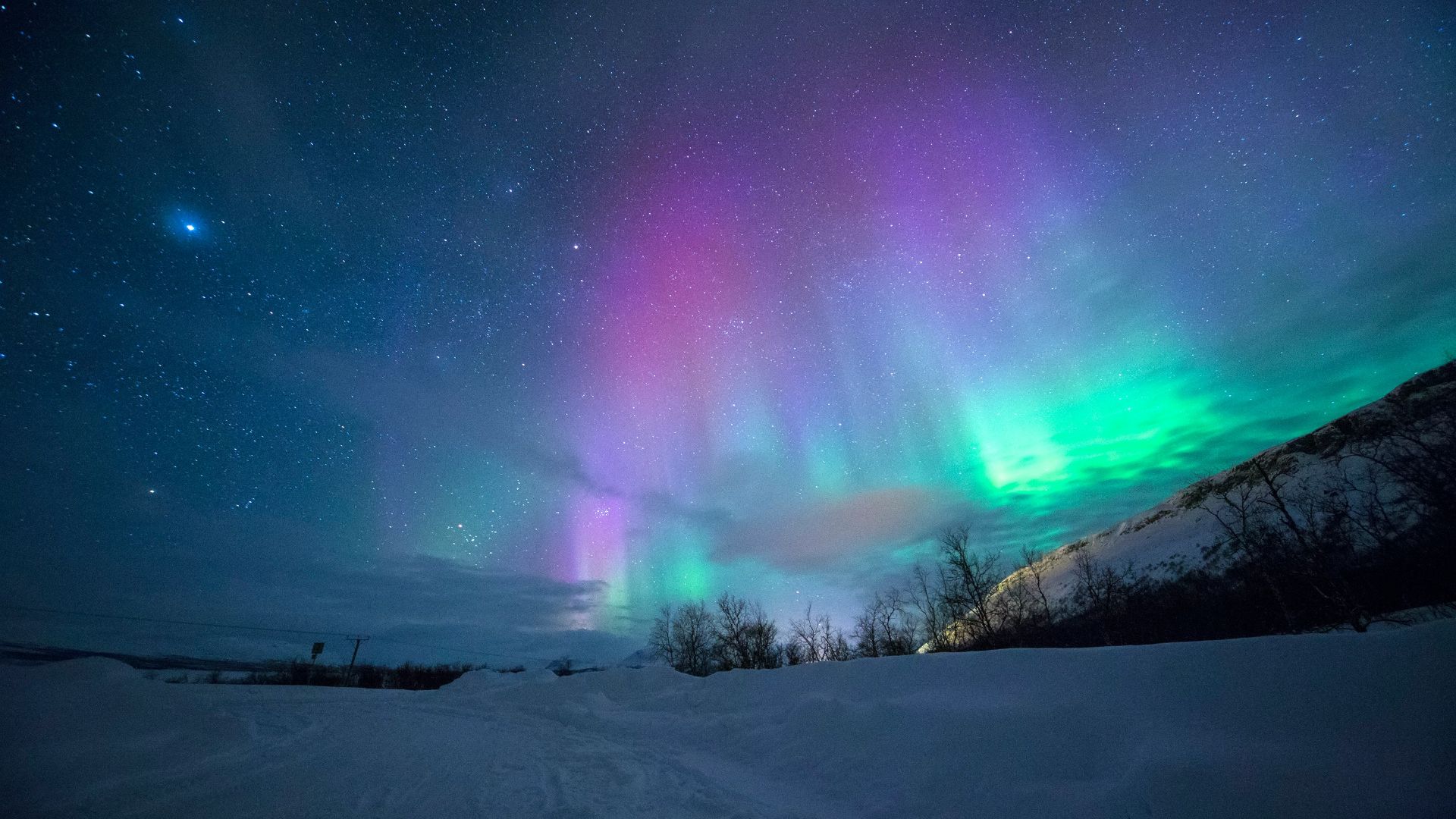 northern lights over snow-capped mountian