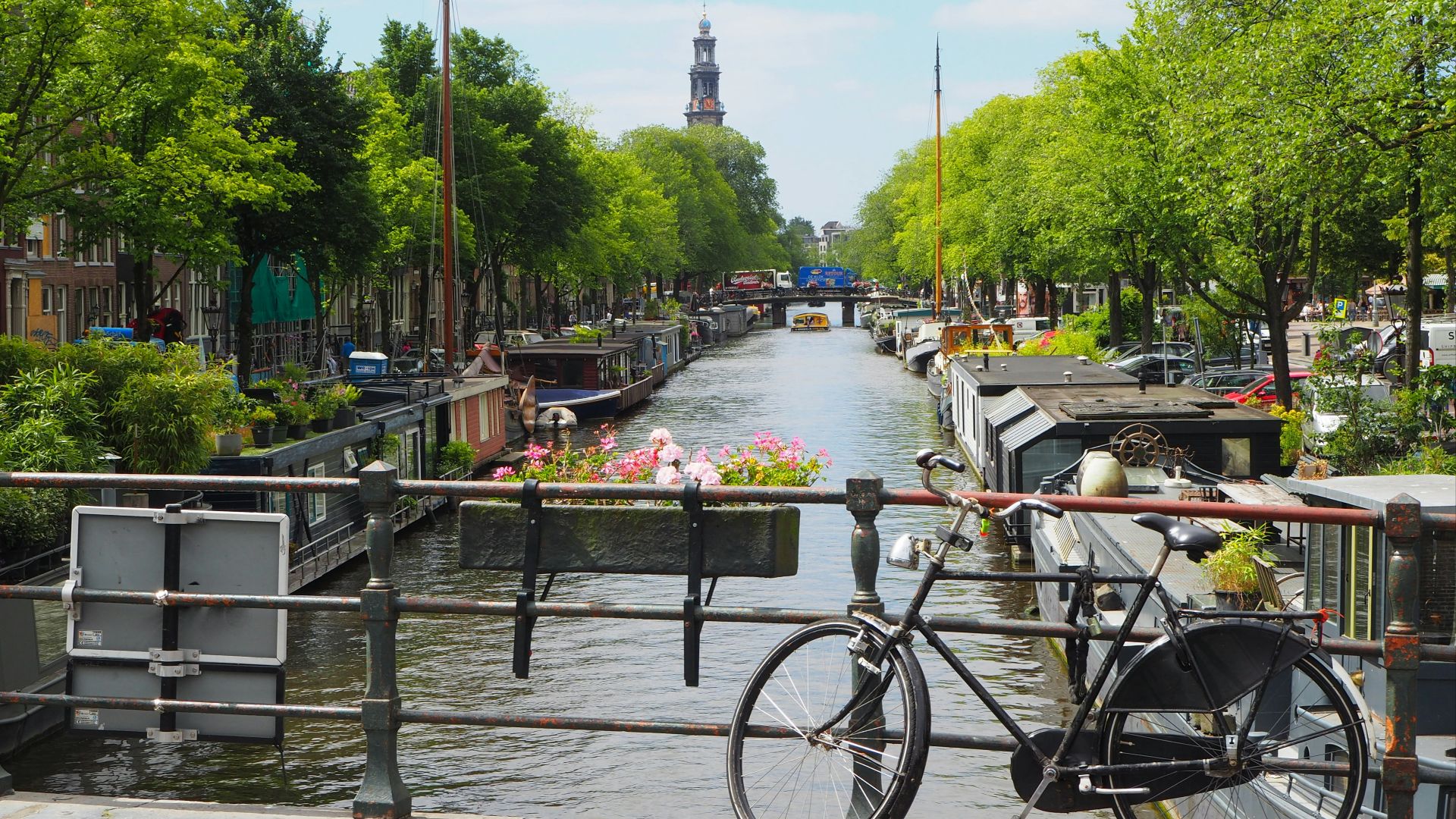 black city bike parked beside river during daytime