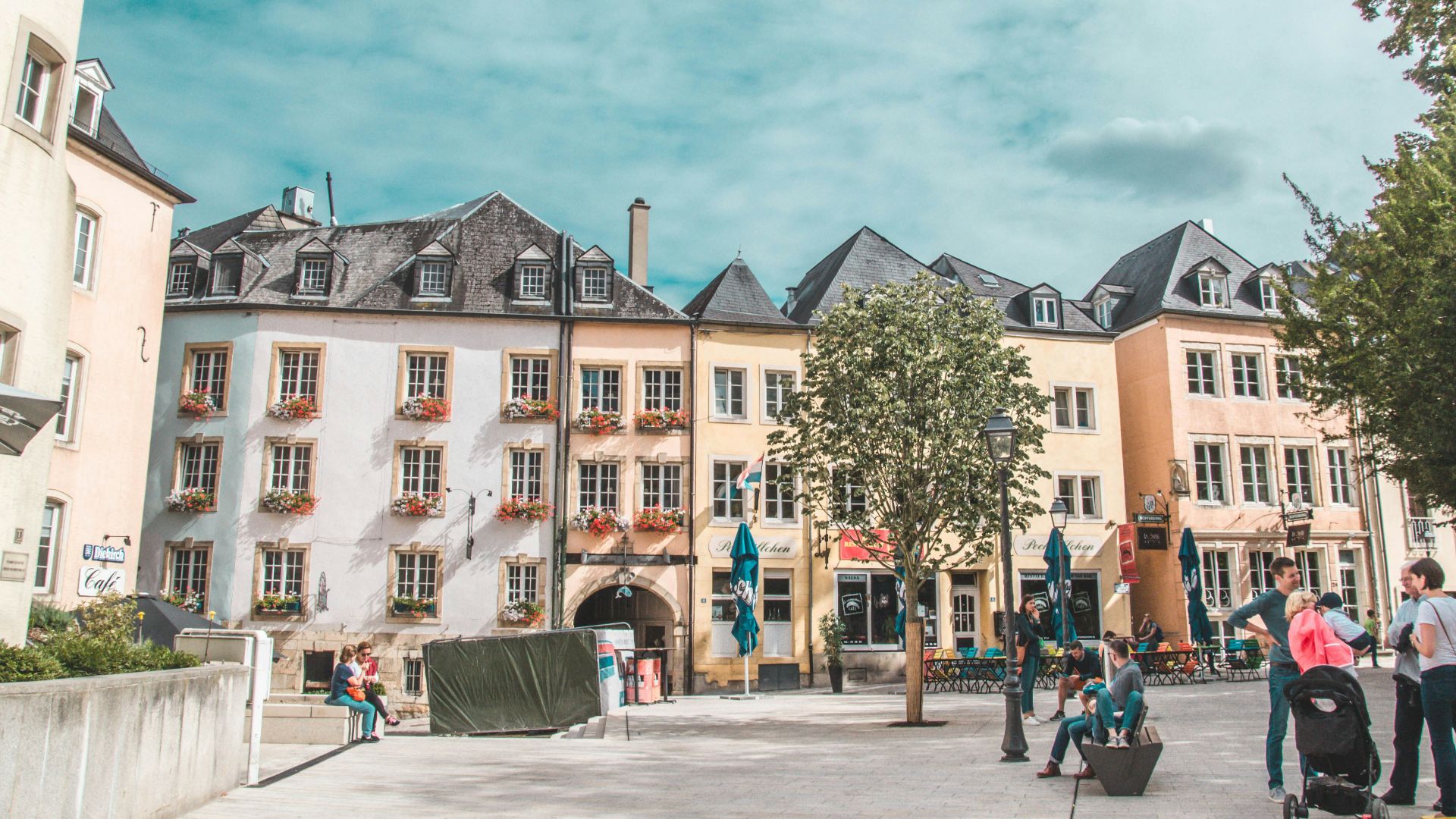 people gathered by buildings during daytime