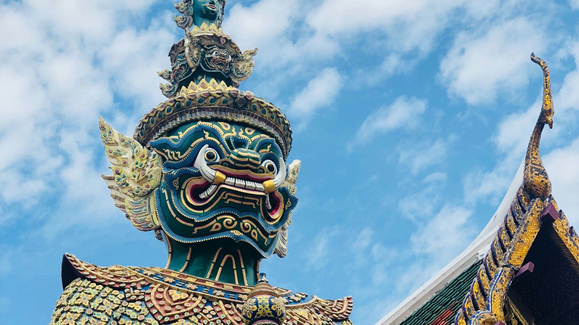 gold and blue dragon statue under blue sky during daytime