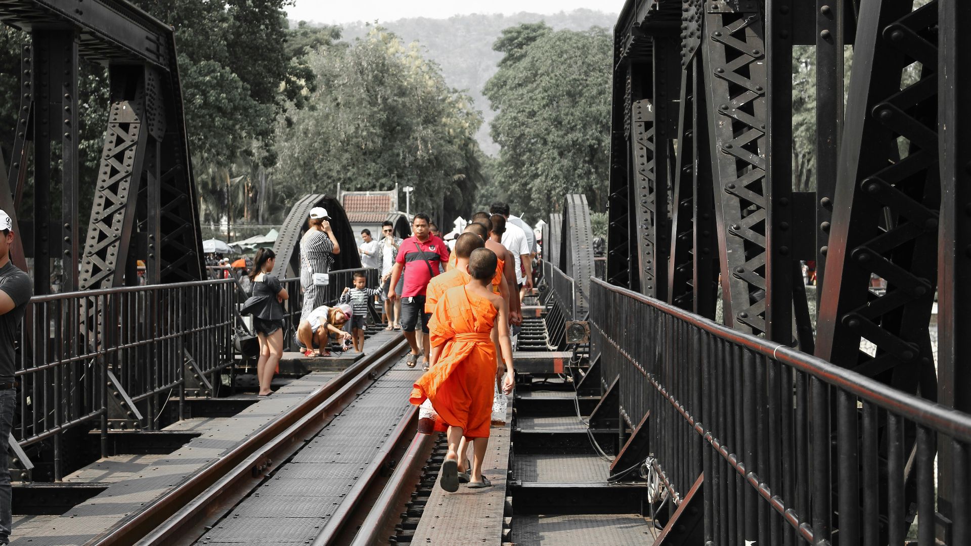 people walking on train rail during daytime
