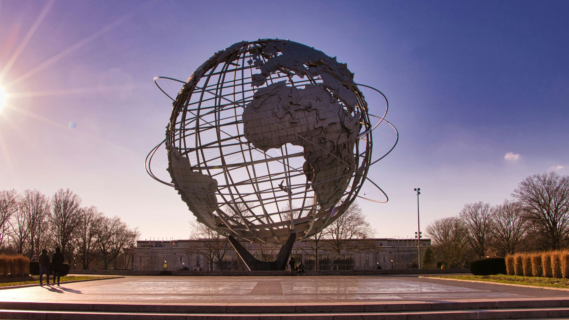 black and white globe statue on brown wooden bench during night time
