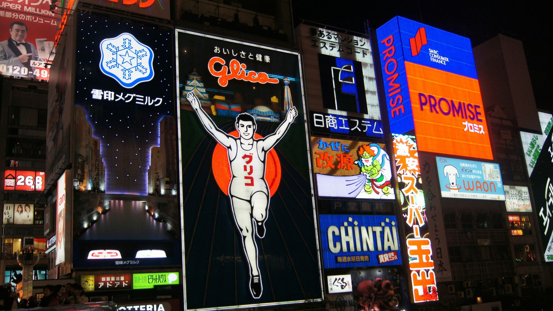 a city street filled with lots of neon signs