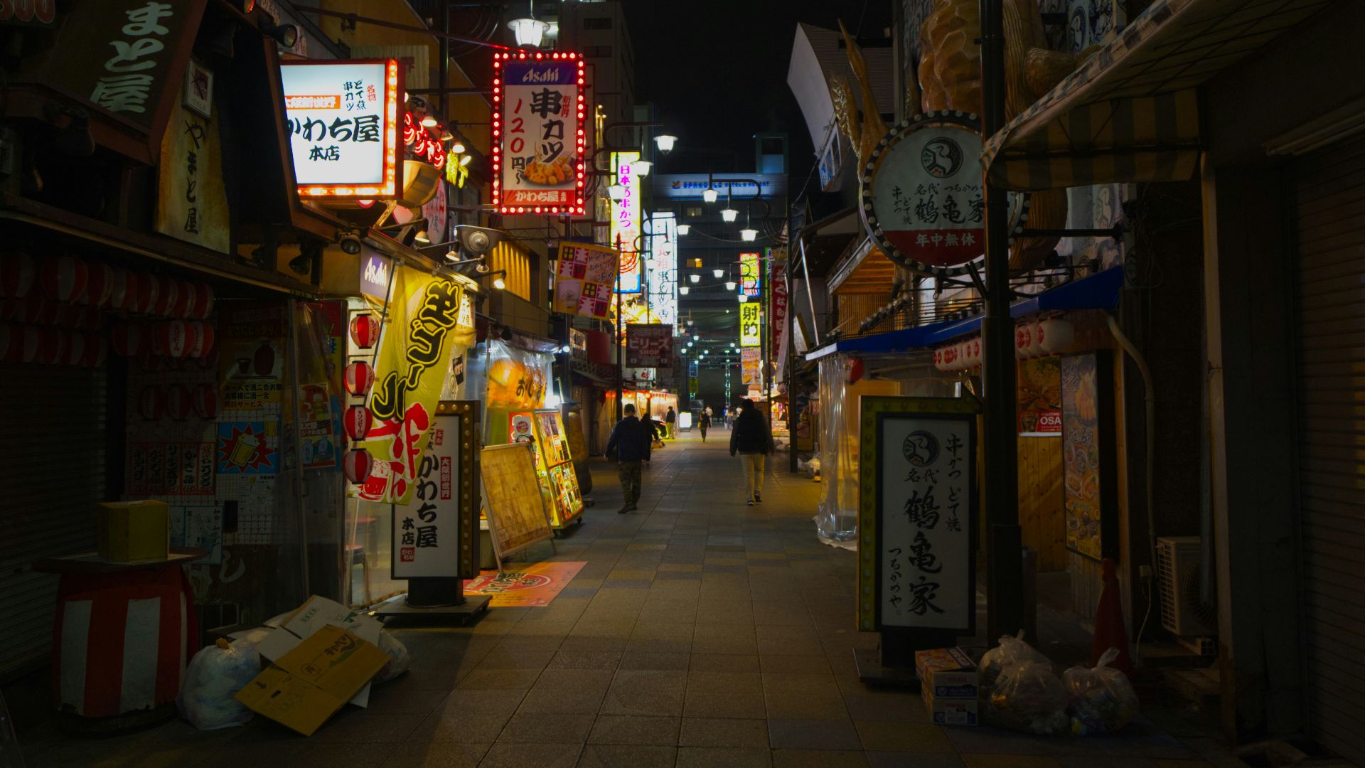 a city street at night with a lot of signs