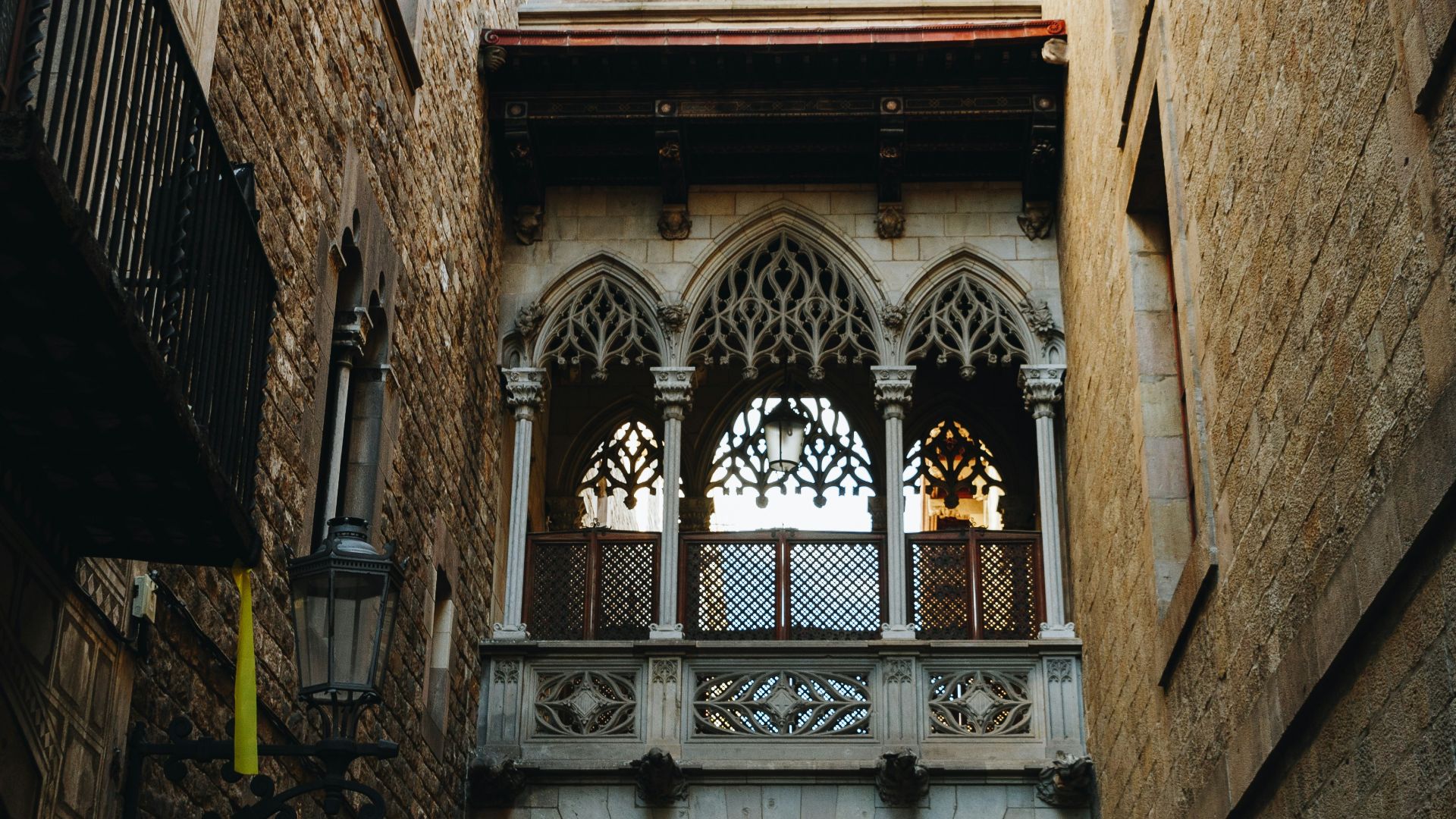 grey concrete archway in between two brown concrete buildings