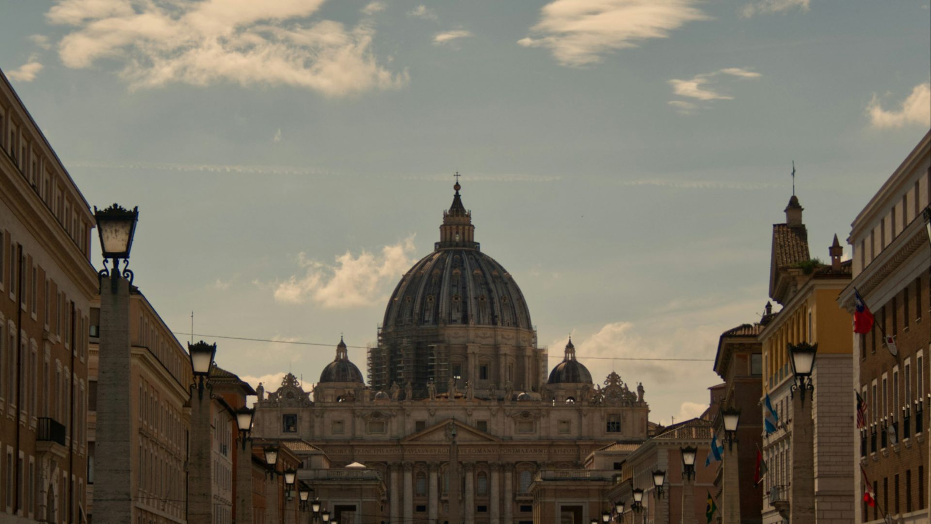 a group of people walking down a cobblestone street