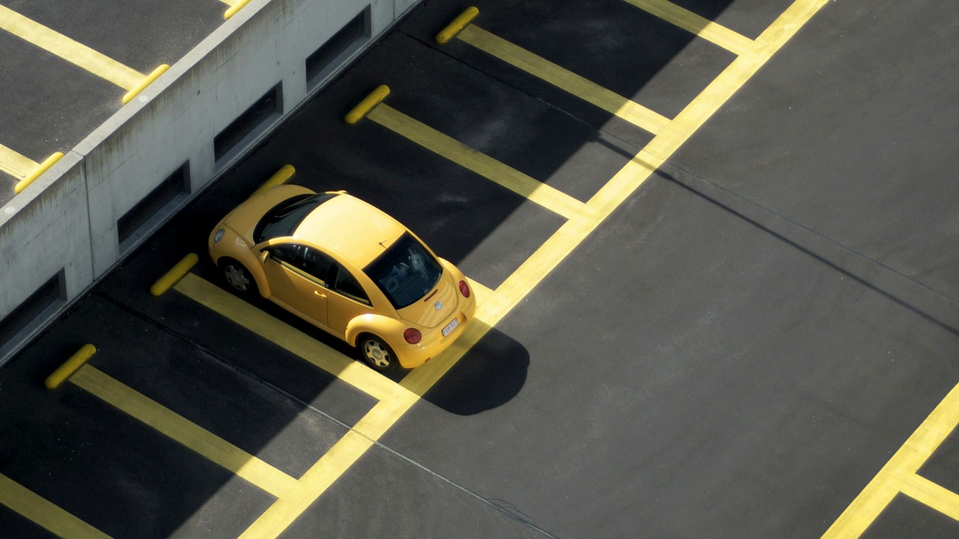 yellow coupe on parking lot at daytime