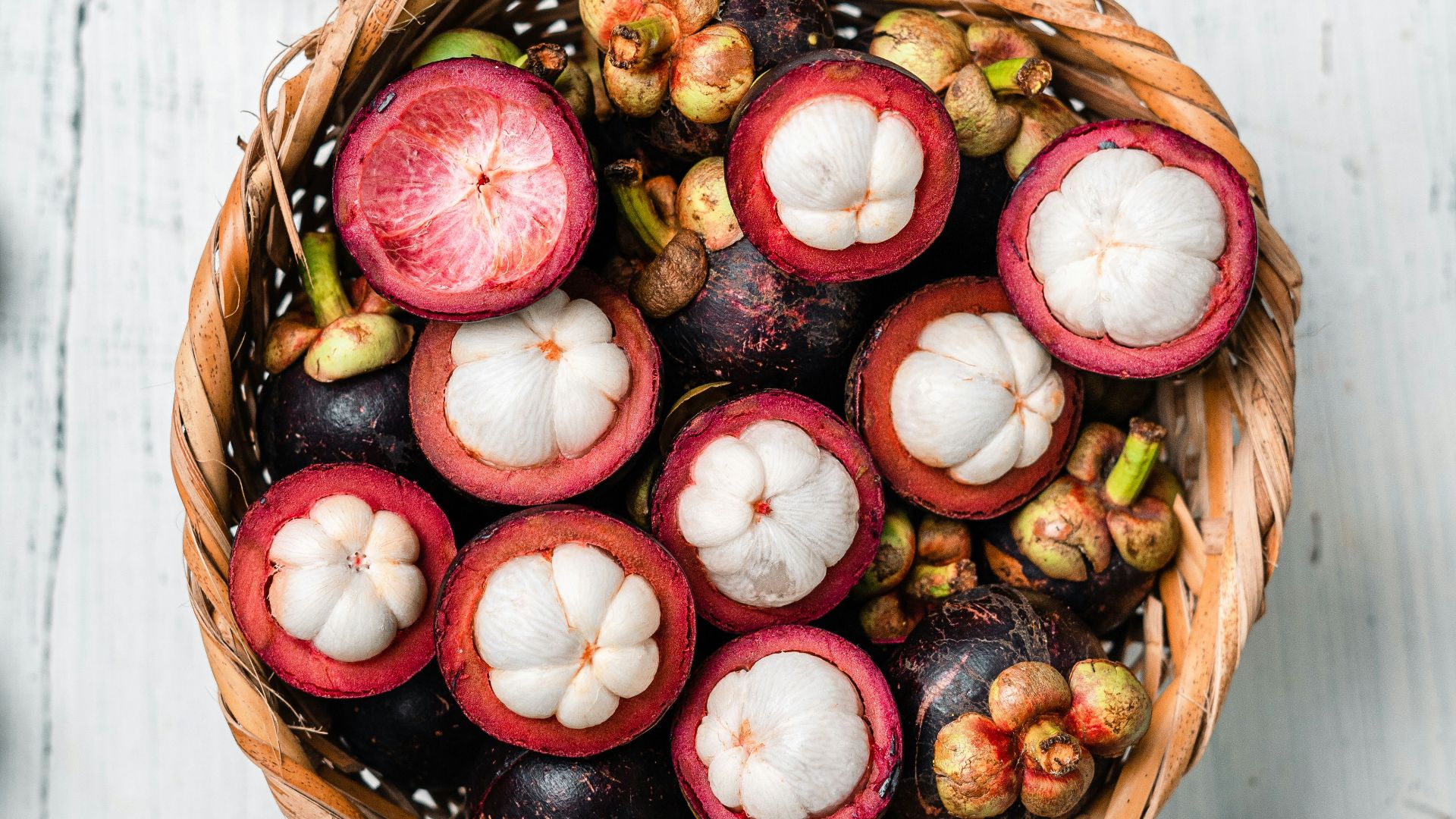 red and white round fruit on brown woven basket