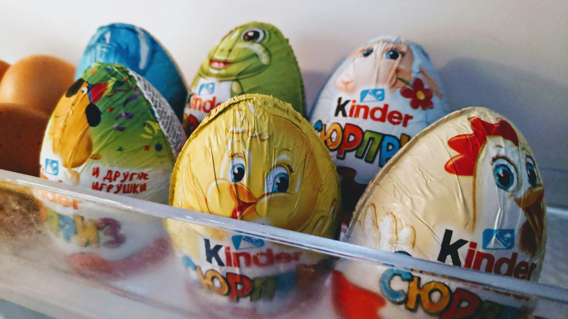 a bunch of kinder eggs in a refrigerator