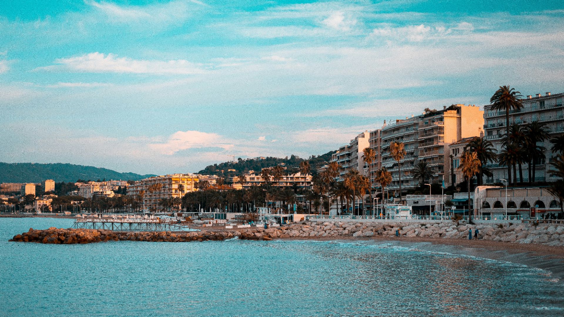 city buildings near body of water under blue sky during daytime