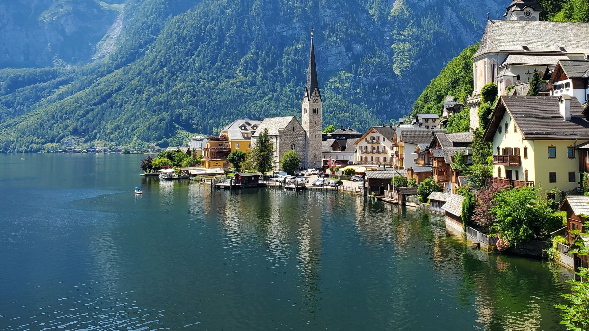 houses near body of water and mountain during daytime