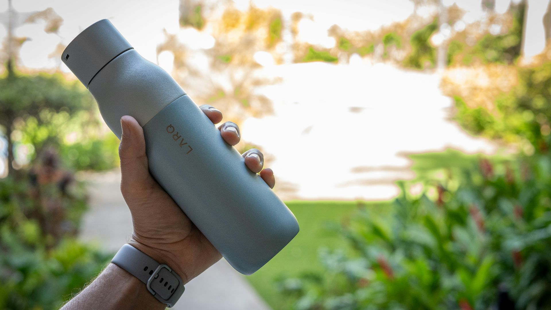 person holding blue and white bottle