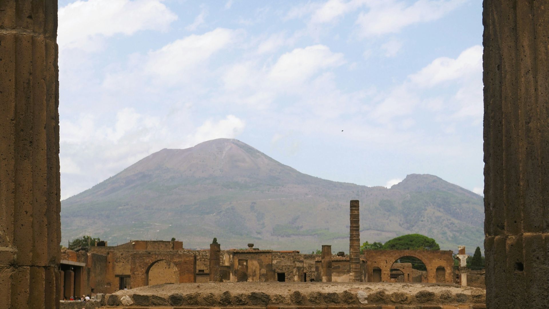 an old building with a mountain in the background