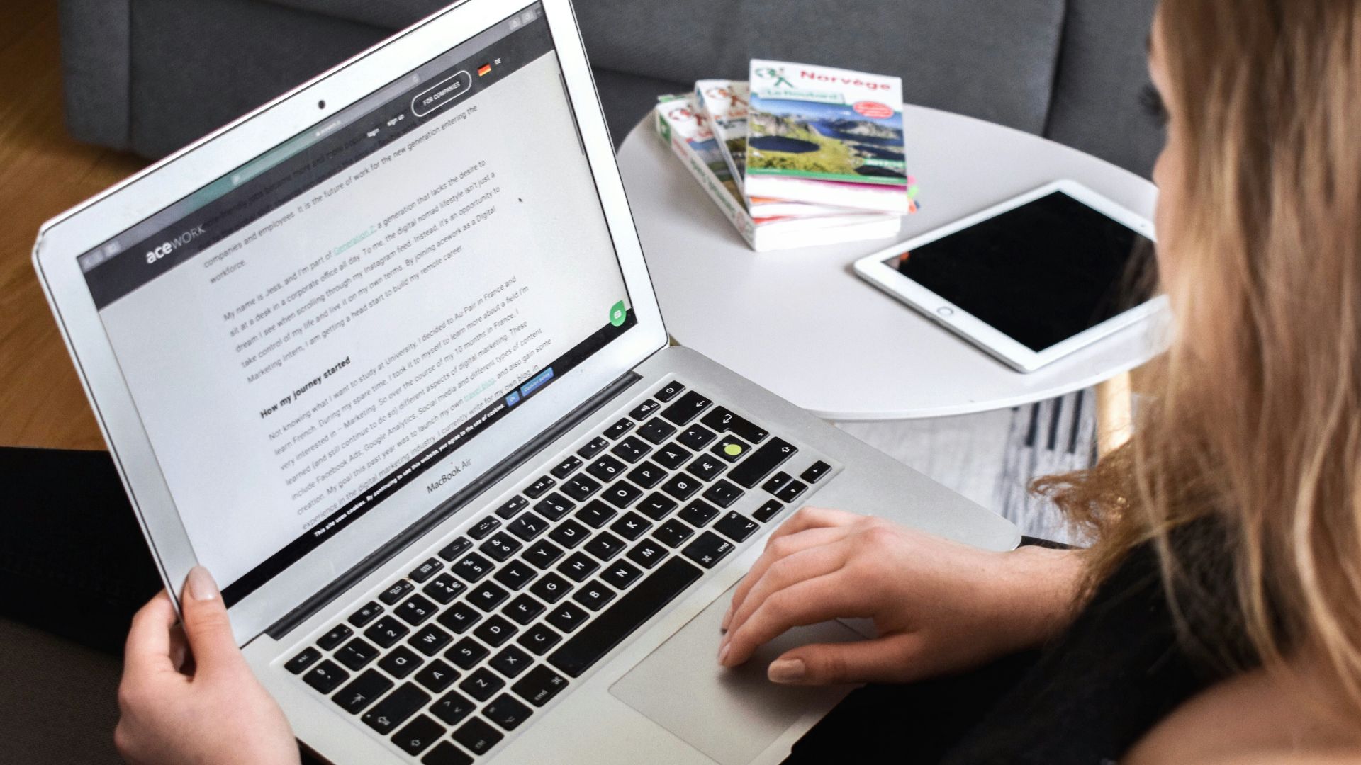 person using macbook air on lap