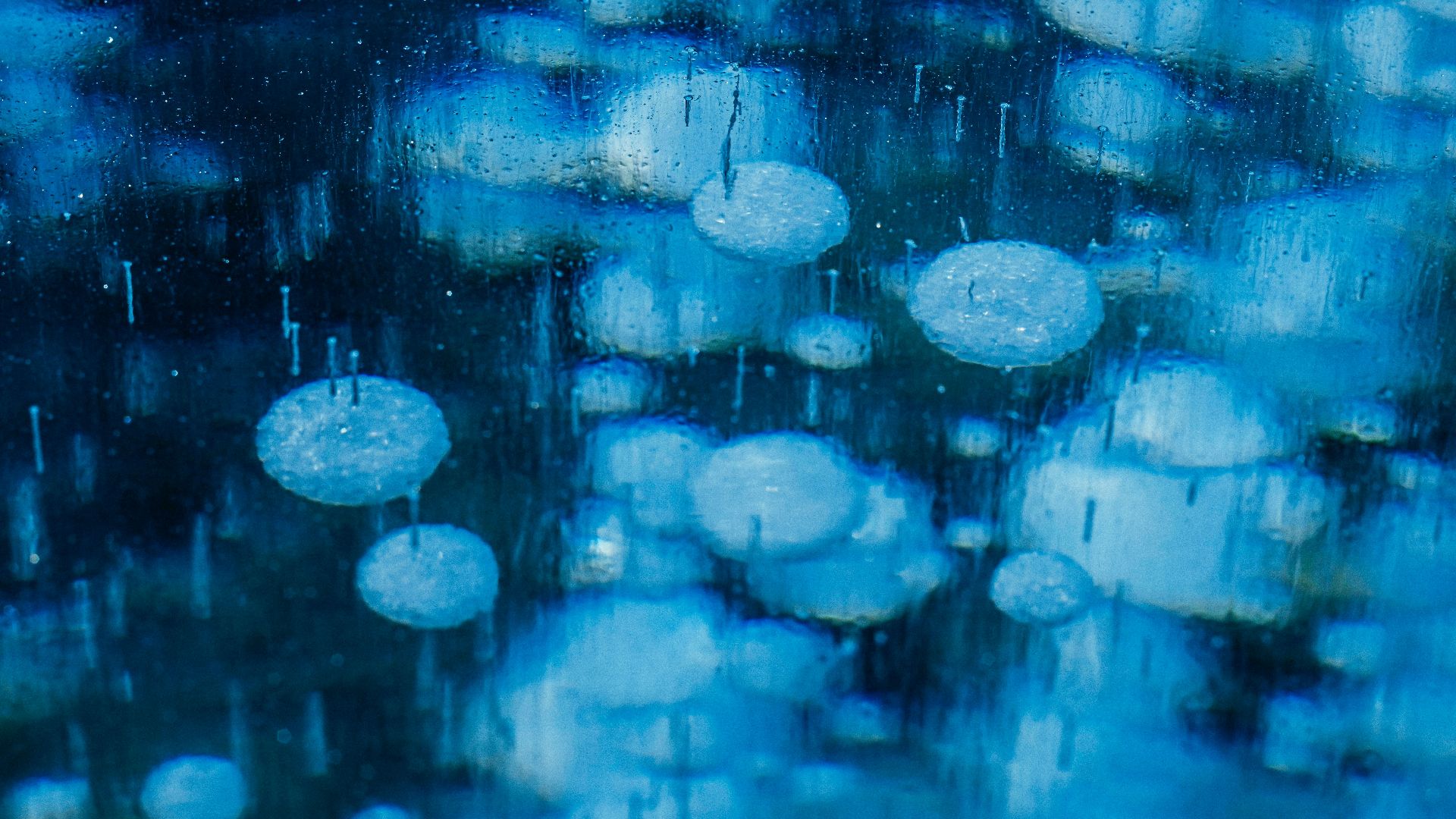 a bunch of umbrellas that are outside in the rain