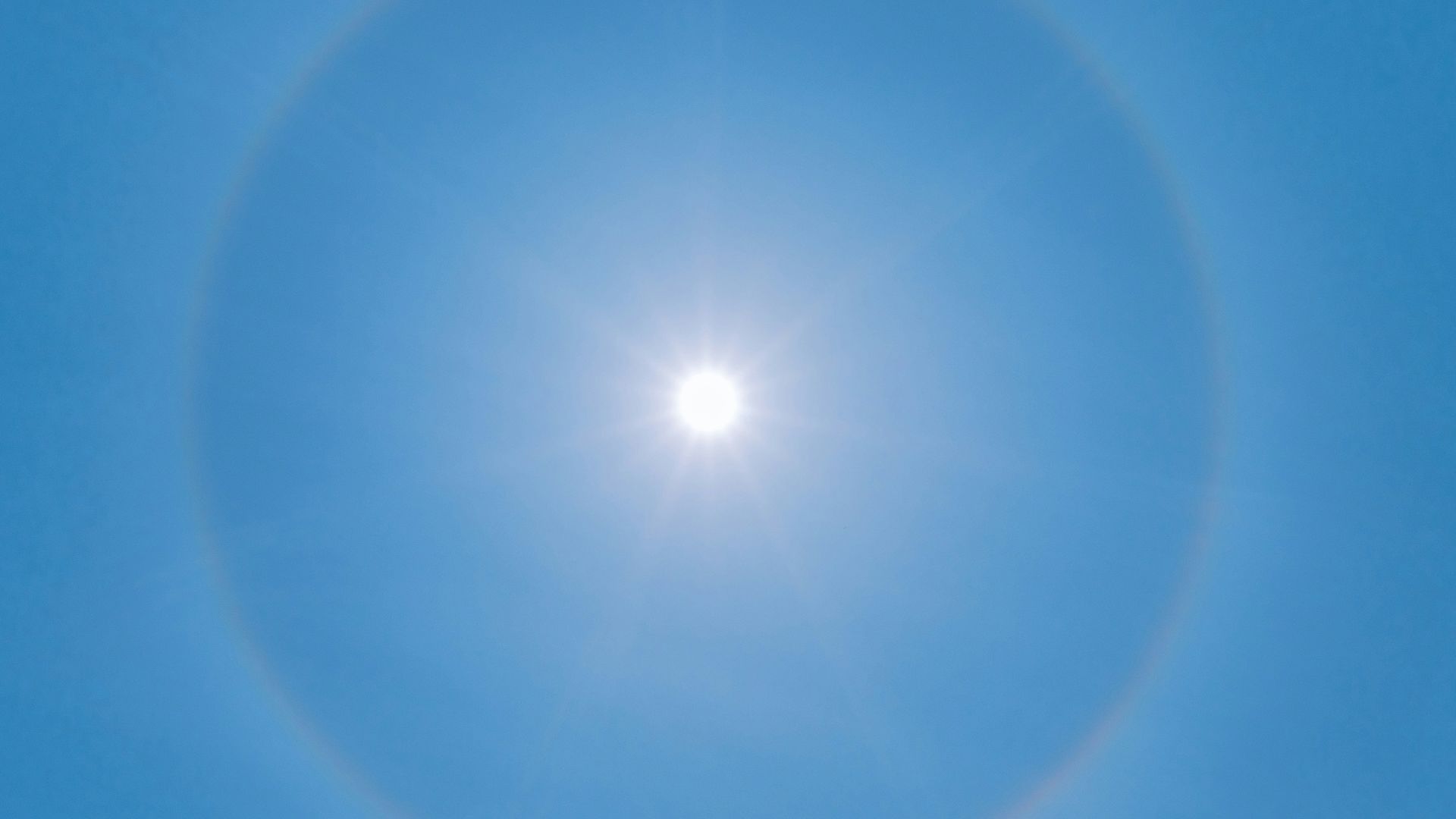 blue sky with white sun