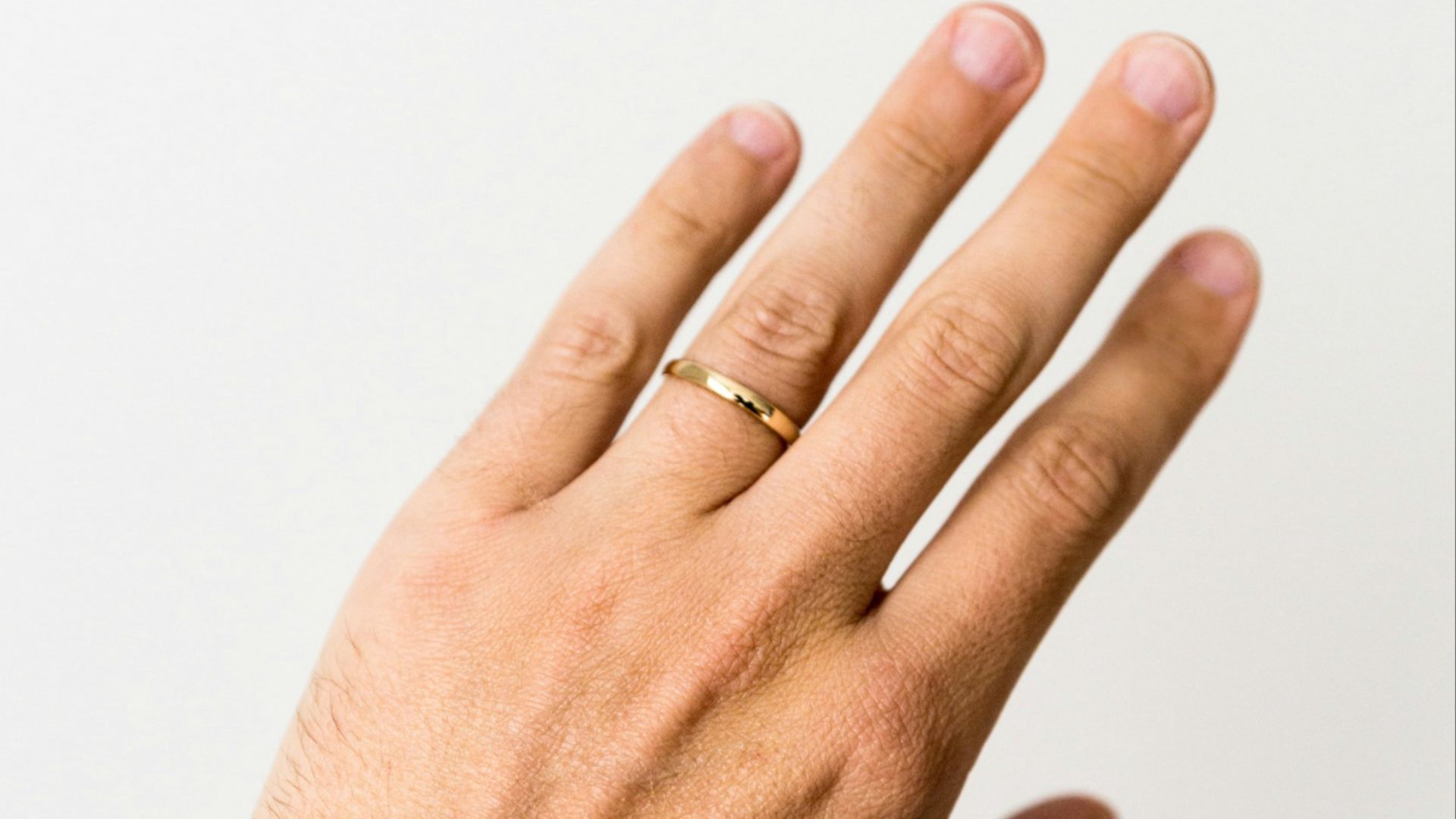 person showing gold-colored ring
