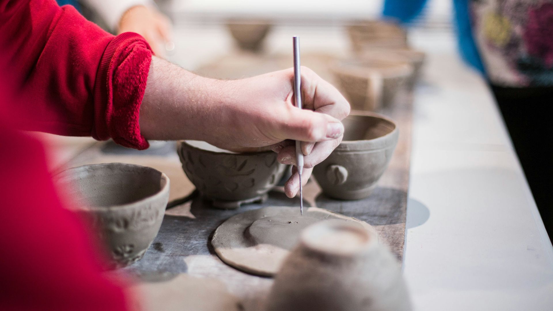 person doing clay containers