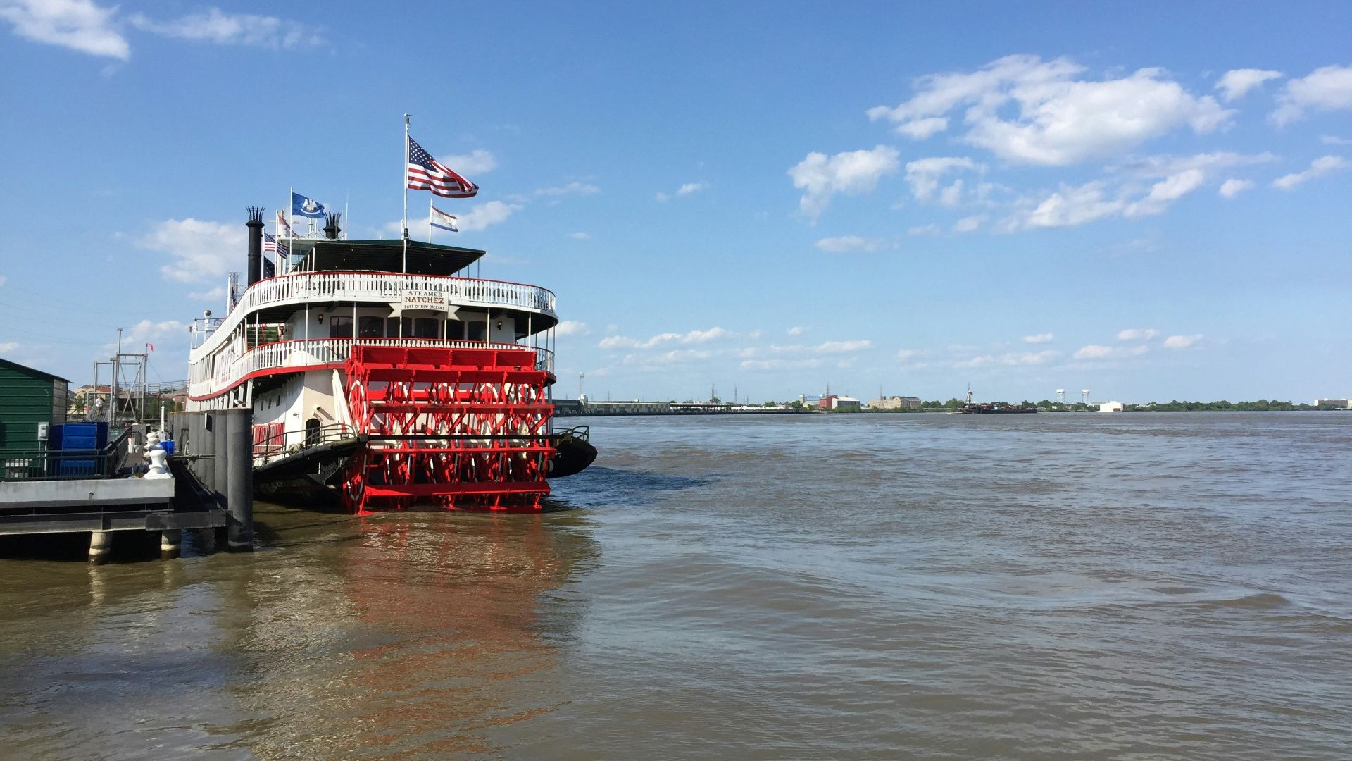 red and white boat on sea under blue sky during daytime