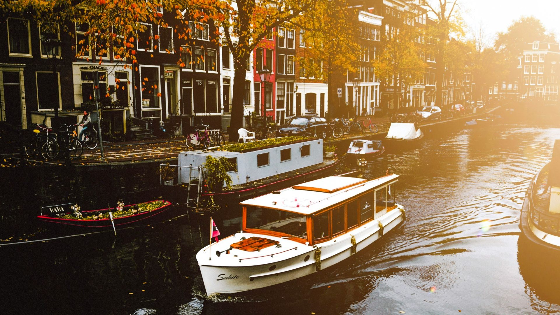 white boat on body of water near buildings during daytime
