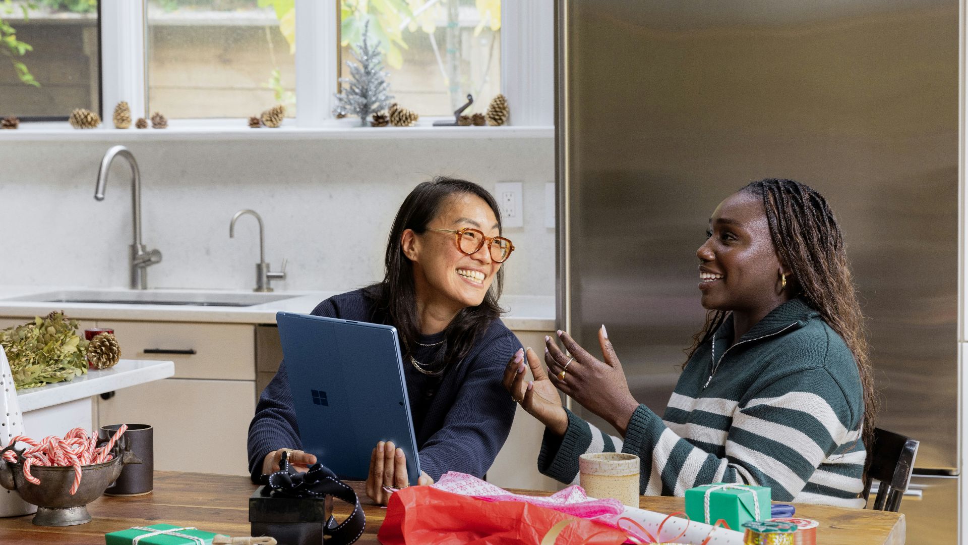 a woman sitting at a table in front of a window