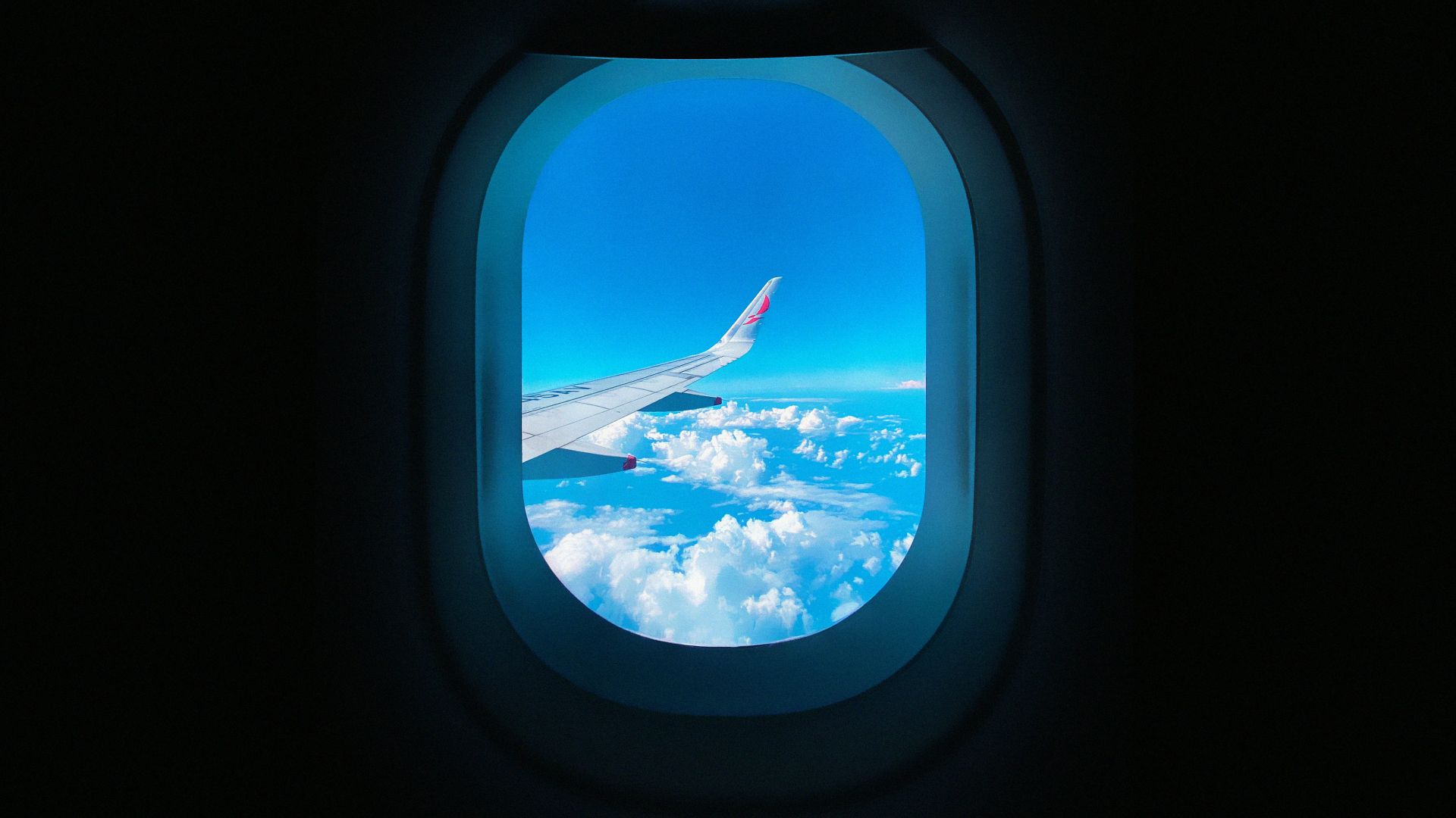 a view of the wing of an airplane through a window