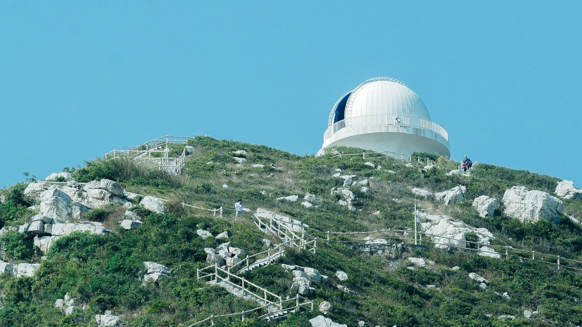 white dome building on top of green mountain during daytime