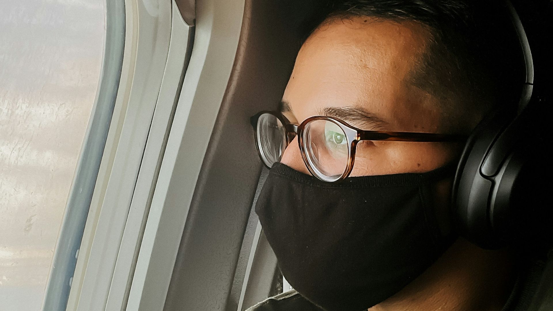 a man in glasses looking at the camera