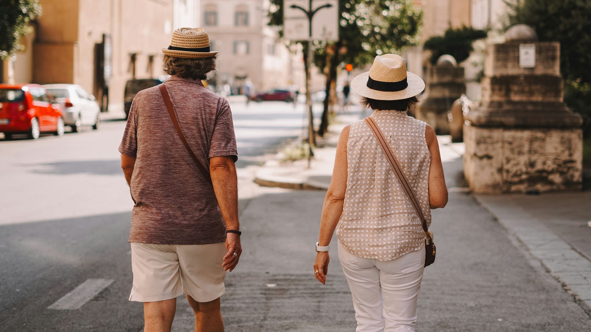 A man and a woman walking down a street