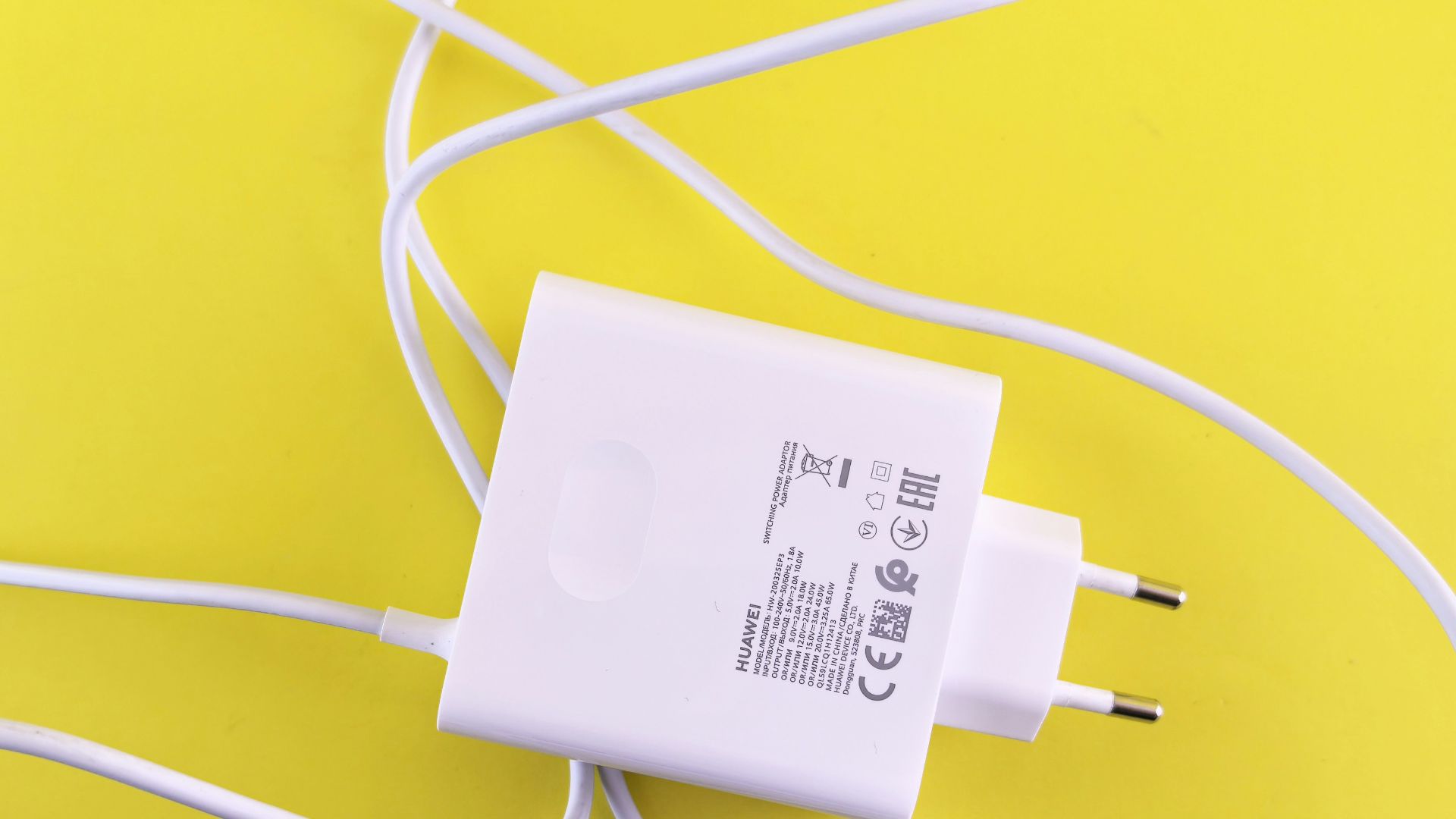 A white cord plugged into a wall charger