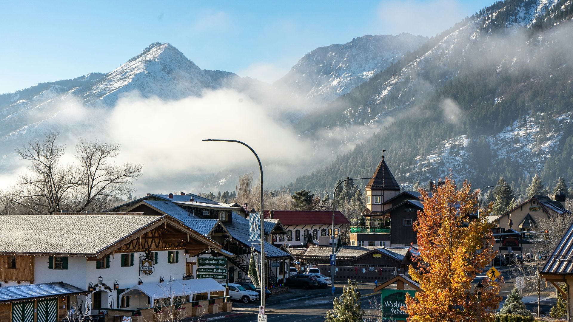brown and white concrete house near mountain during daytime
