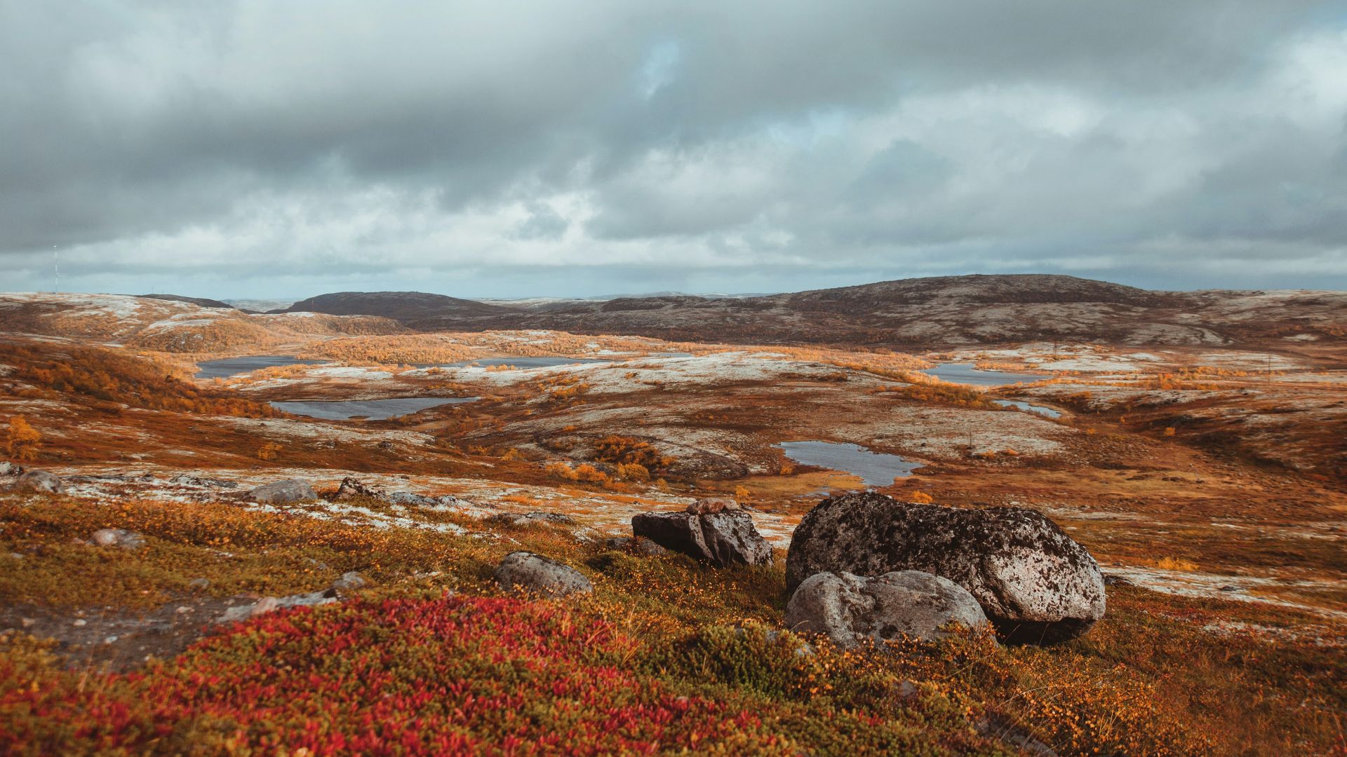 a rocky landscape with a body of water in the distance