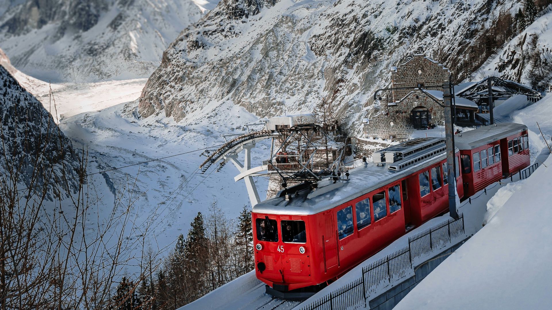 red and white train on snow covered mountain during daytime