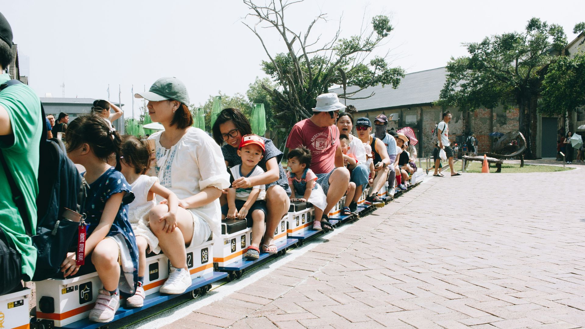 people sitting on train ride near outdoor during daytime