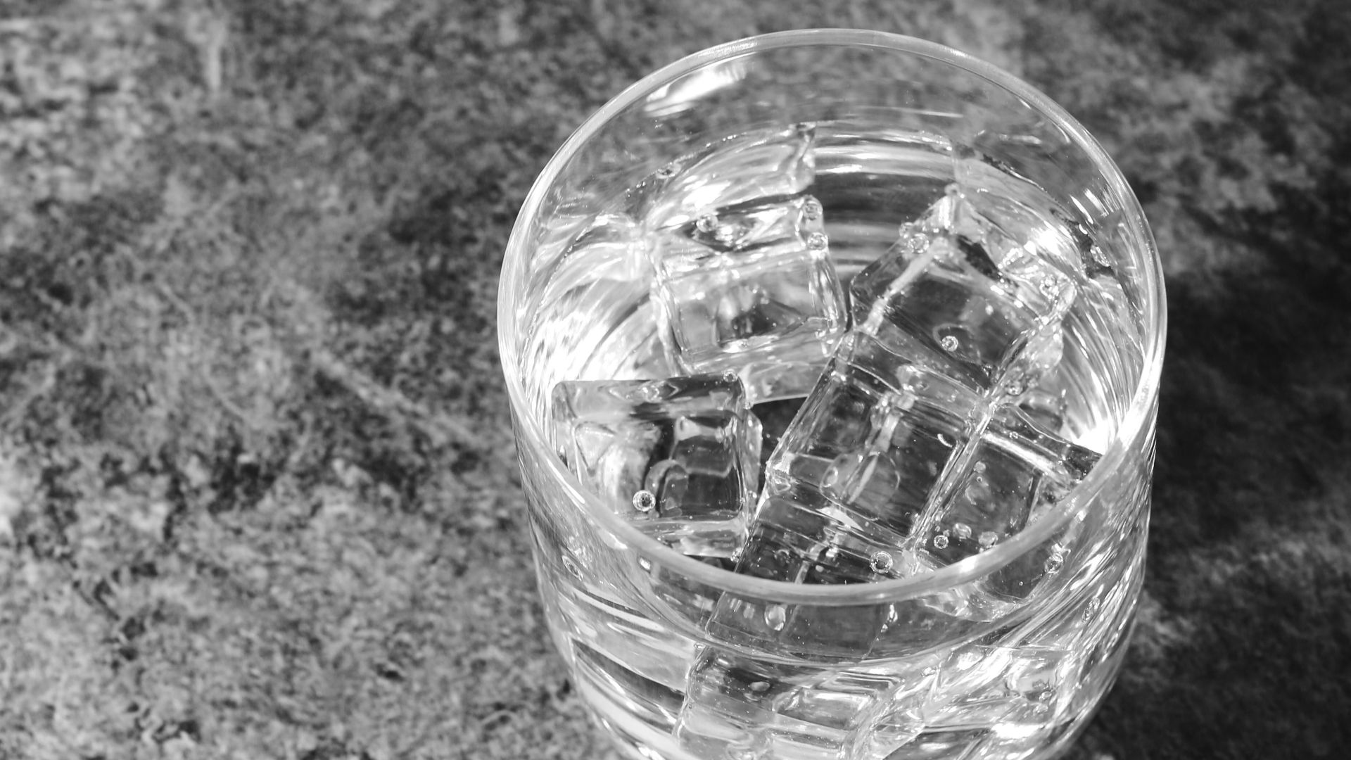 clear glass cup on gray textile