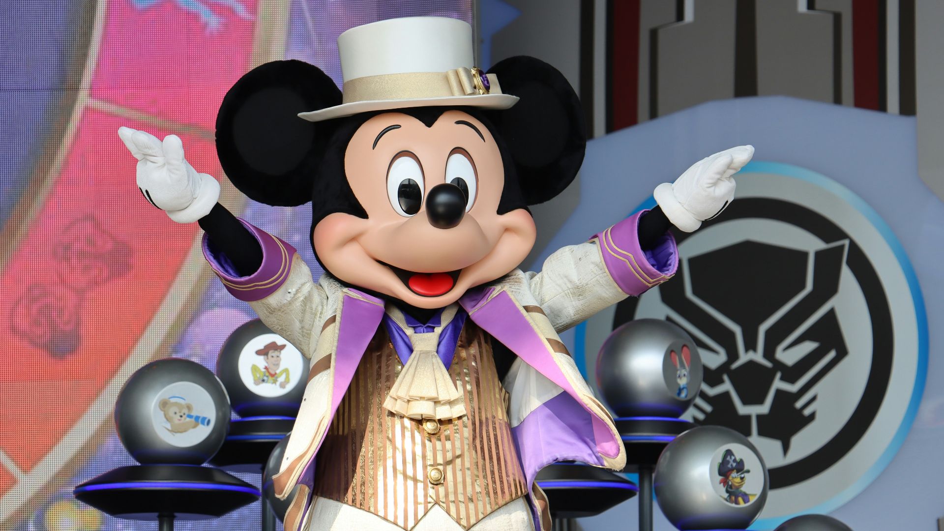 a mickey mouse dressed in a top hat and suit