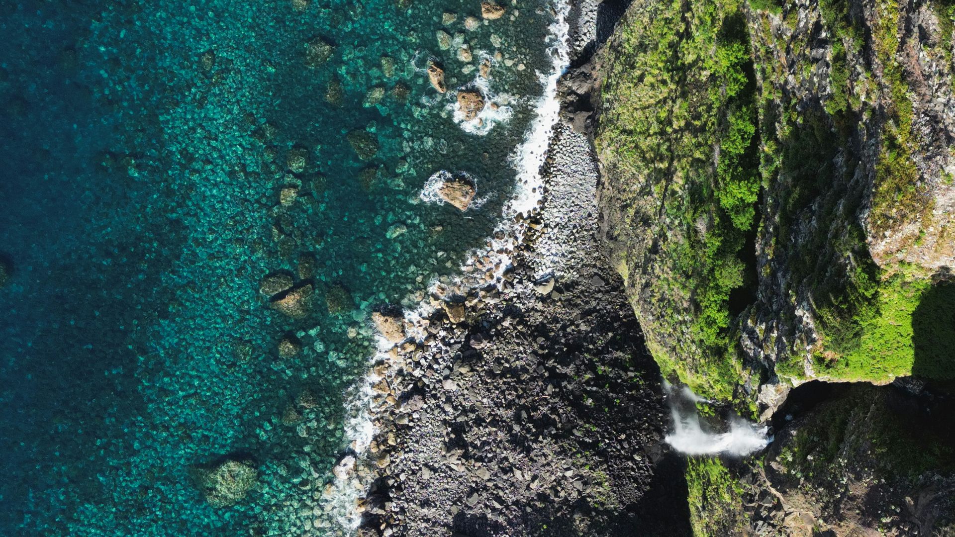 a bird's eye view of the ocean and cliffs