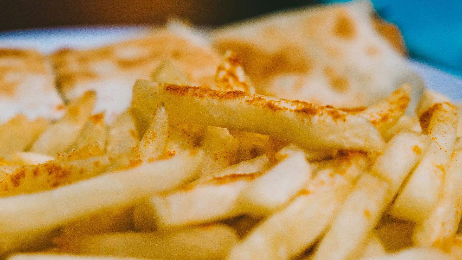 A plate of french fries and quesadillas on a table